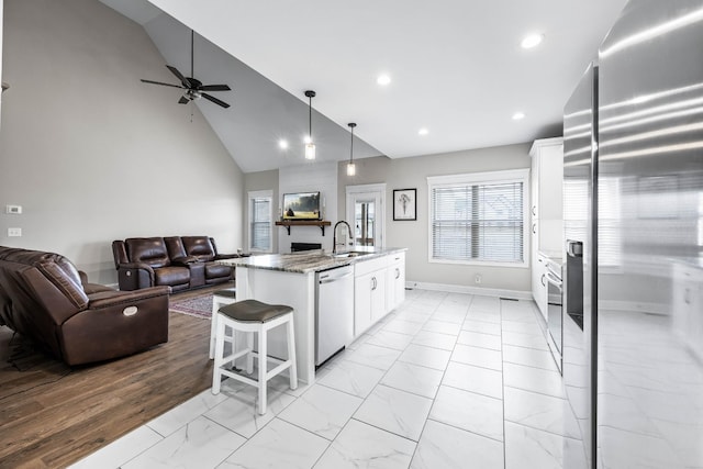 1103 Chagford Dr, Clarksville, TN 37043 - kitchen with appliances with stainless steel finishes, open floor plan, light marble finish floors, white cabinetry, and recessed lighting