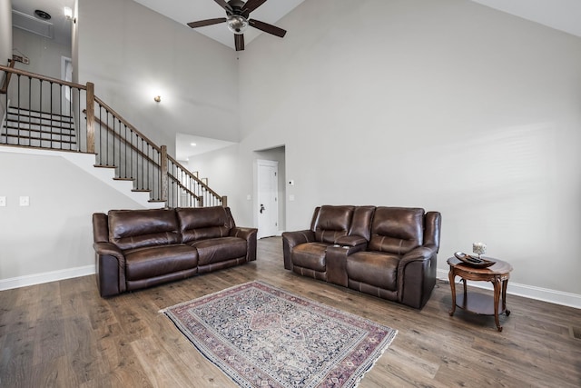 1103 Chagford Dr, Clarksville, TN 37043 - living area featuring a ceiling fan, wood finished floors, stairway, high vaulted ceiling, and baseboards