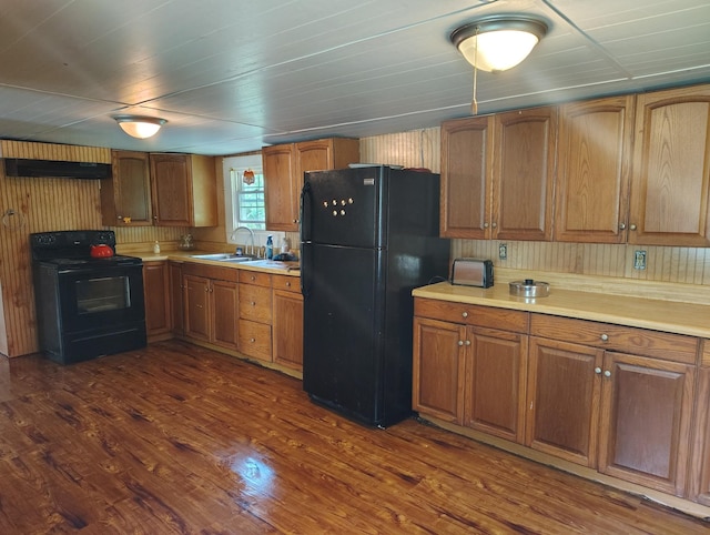 1004 Haydenburg Rd, Whitleyville, TN 38588 - kitchen with black appliances, light countertops, brown cabinetry, and dark wood finished floors