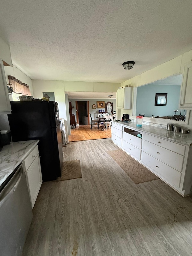 41 Park Dr, Beechmont, KY 42323 - kitchen with dishwasher, wood finished floors, a textured ceiling, freestanding refrigerator, and white cabinetry