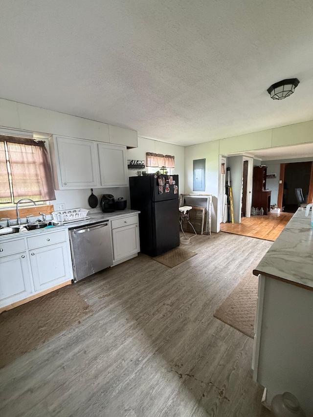 41 Park Dr, Beechmont, KY 42323 - kitchen featuring stainless steel dishwasher, freestanding refrigerator, a sink, white cabinets, and a textured ceiling