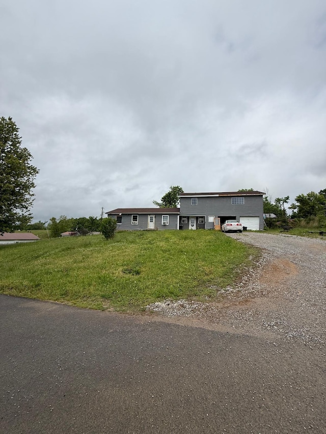 41 Park Dr, Beechmont, KY 42323 - view of front of property featuring dirt driveway, a front lawn, and a garage