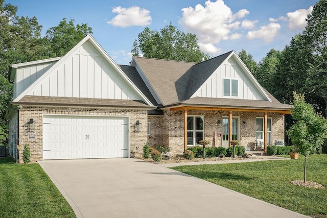 3050 Westowne Cir, Cookeville, TN 38501 - view of front of house with board and batten siding, brick siding, a garage, and a front lawn