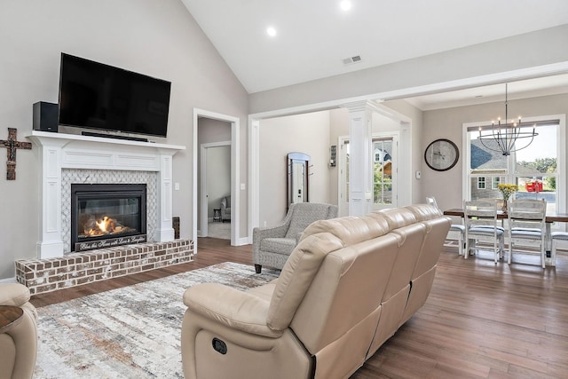 3050 Westowne Cir, Cookeville, TN 38501 - living area with a chandelier, wood finished floors, a brick fireplace, recessed lighting, and high vaulted ceiling