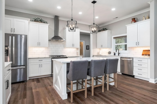 3050 Westowne Cir, Cookeville, TN 38501 - kitchen featuring stainless steel appliances, wall chimney exhaust hood, a center island, decorative backsplash, and ornamental molding