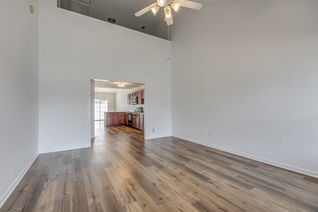 2026 Caladonia Way, Smyrna, TN 37167 - empty room with a ceiling fan, a high ceiling, wood finished floors, and baseboards