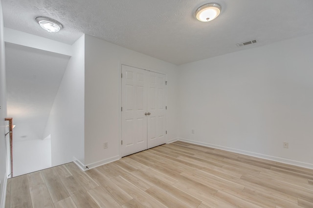 2026 Caladonia Way, Smyrna, TN 37167 - unfurnished bedroom featuring light wood finished floors, baseboards, a textured ceiling, and a closet