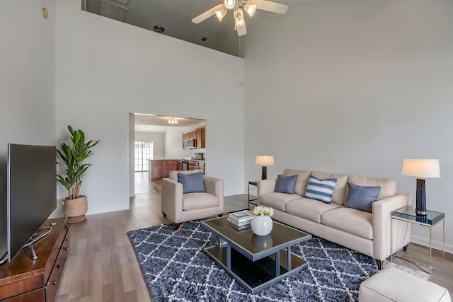 2026 Caladonia Way, Smyrna, TN 37167 - living area with ceiling fan, a high ceiling, wood finished floors, and baseboards