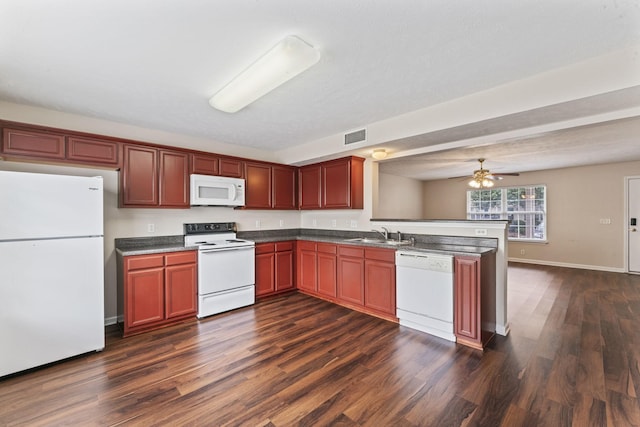 304 Shoshone Pl, Murfreesboro, TN 37128 - kitchen featuring white appliances, dark wood-type flooring, a peninsula, and dark countertops