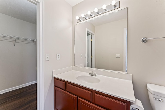 304 Shoshone Pl, Murfreesboro, TN 37128 - bathroom featuring vanity, wood finished floors, and a walk in closet