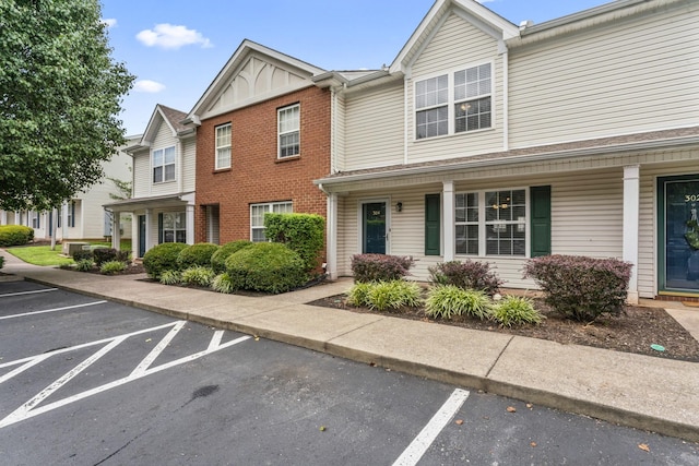 304 Shoshone Pl, Murfreesboro, TN 37128 - multi unit property featuring uncovered parking, a porch, board and batten siding, and brick siding