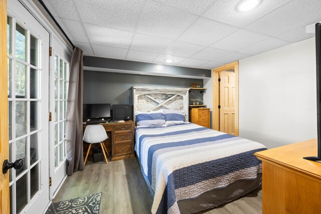 211 Hood St, Dover, TN 37058 - bedroom featuring wood finished floors, a paneled ceiling, an office area, and french doors