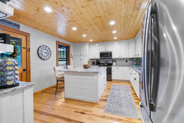 211 Hood St, Dover, TN 37058 - kitchen with appliances with stainless steel finishes, a center island, recessed lighting, white cabinets, and wooden ceiling