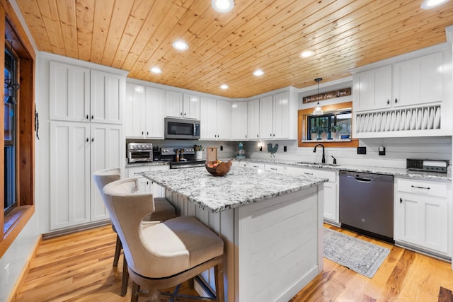 211 Hood St, Dover, TN 37058 - kitchen featuring stainless steel appliances, a sink, wooden ceiling, a kitchen island, and white cabinetry