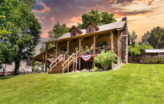 211 Hood St, Dover, TN 37058 - back of house at dusk with a chimney, a porch, and a shingled roof