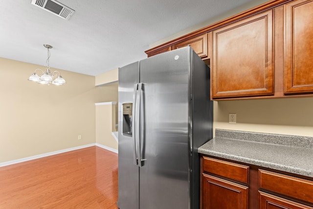1036 Harold Lee Dr, Smyrna, TN 37167 - kitchen featuring stainless steel fridge, a chandelier, light wood-style floors, baseboards, and decorative light fixtures