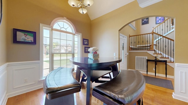 1032 Stonehollow Way, Mount Juliet, TN 37122 - dining area with arched walkways, a wainscoted wall, light wood finished floors, lofted ceiling, and stairway