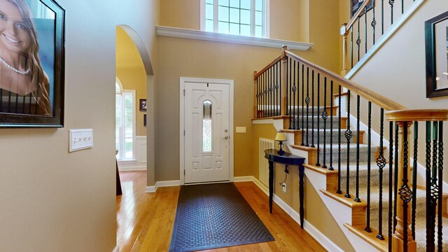 1032 Stonehollow Way, Mount Juliet, TN 37122 - foyer with wood finished floors, arched walkways, stairs, baseboards, and a high ceiling