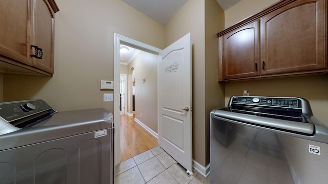 1032 Stonehollow Way, Mount Juliet, TN 37122 - washroom featuring cabinet space, washing machine and clothes dryer, light tile patterned floors, and baseboards
