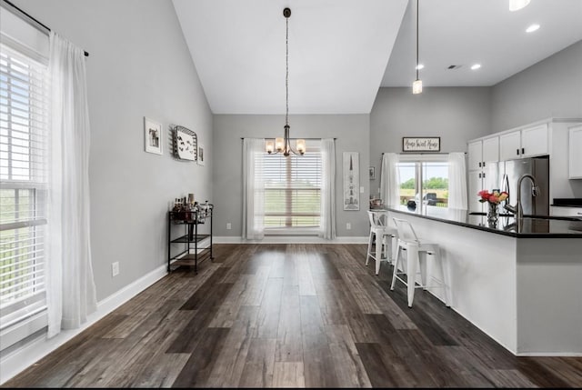 720 Jersey Dr, Clarksville, TN 37043 - kitchen featuring a chandelier, high vaulted ceiling, dark wood-style flooring, dark countertops, and white cabinetry