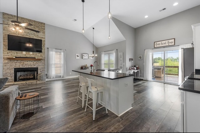 720 Jersey Dr, Clarksville, TN 37043 - kitchen featuring dark countertops, high vaulted ceiling, a ceiling fan, dark wood-style floors, and white cabinets