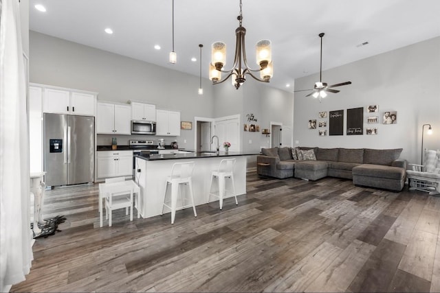 720 Jersey Dr, Clarksville, TN 37043 - living room featuring high vaulted ceiling, a ceiling fan, dark wood-style floors, a chandelier, and recessed lighting