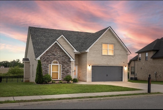 720 Jersey Dr, Clarksville, TN 37043 - view of front of house with a garage, driveway, brick siding, and roof with shingles