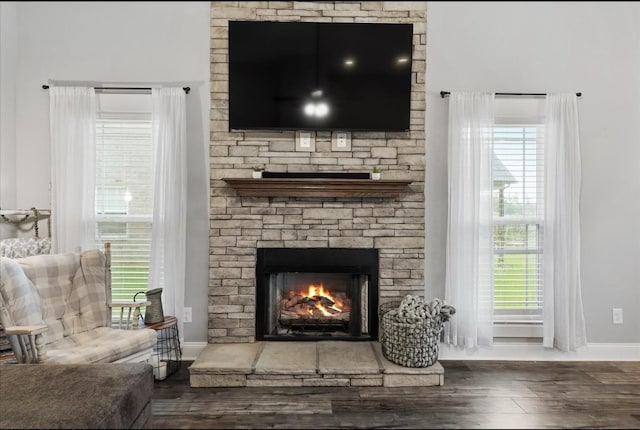 720 Jersey Dr, Clarksville, TN 37043 - living room featuring baseboards, wood finished floors, a stone fireplace, and plenty of natural light