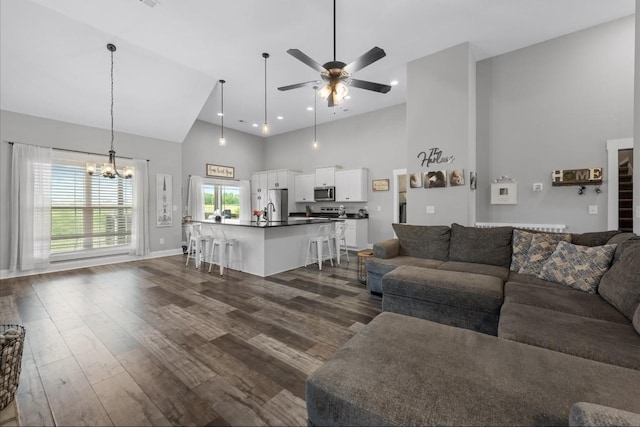 720 Jersey Dr, Clarksville, TN 37043 - living area featuring high vaulted ceiling, a ceiling fan, dark wood-type flooring, a chandelier, and baseboards