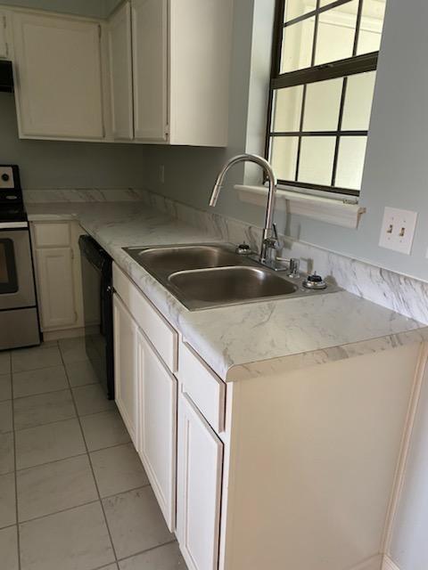 125 Ellington Pl, Madison, TN 37115 - kitchen featuring stainless steel electric range, dishwasher, a sink, white cabinets, and light tile patterned floors