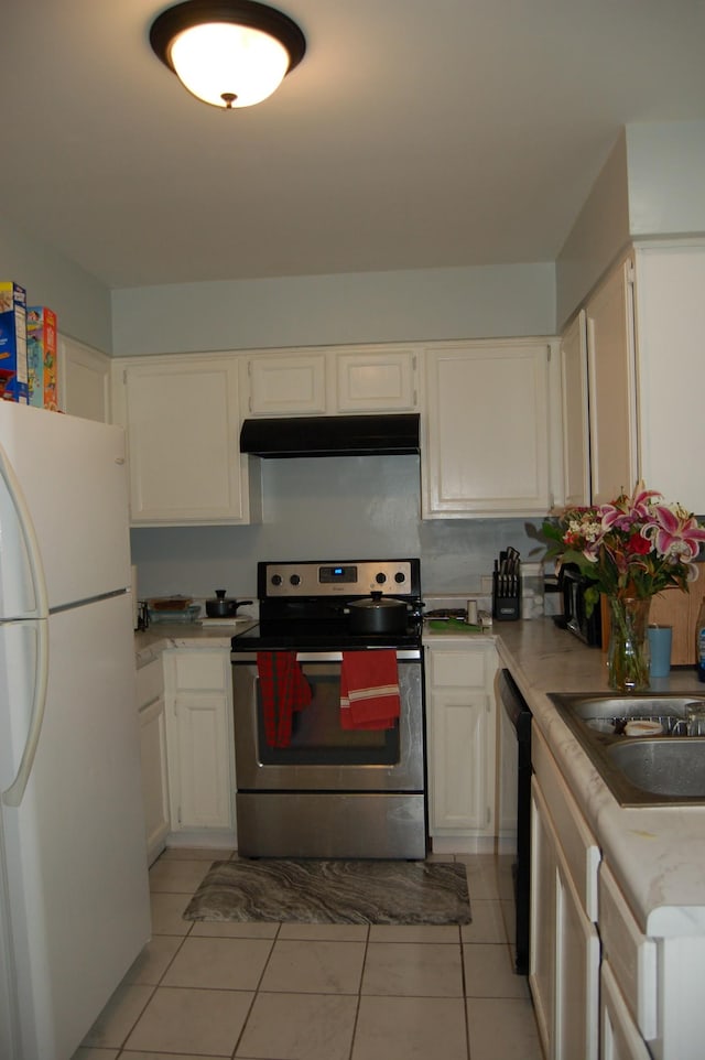 125 Ellington Pl, Madison, TN 37115 - kitchen with stainless steel electric range oven, freestanding refrigerator, under cabinet range hood, dishwasher, and light tile patterned floors