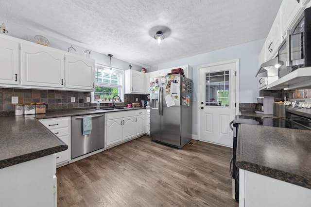 530 Maplewood Dr, Cornersville, TN 37047 - kitchen with stainless steel appliances, dark countertops, a sink, white cabinetry, and a textured ceiling