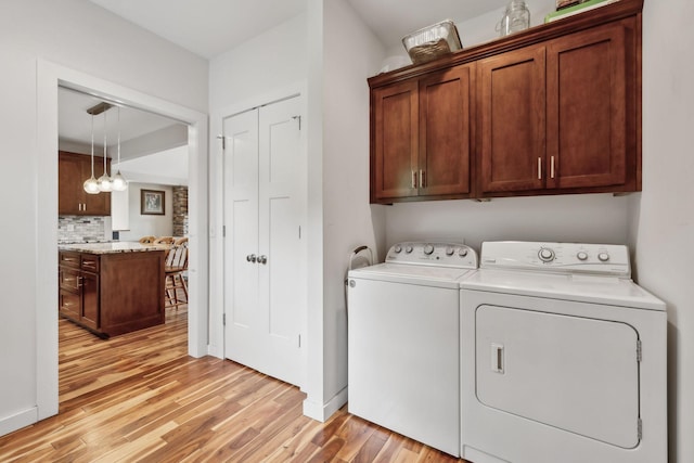 225 Ferguson Creek Rd, Sparta, TN 38583 - laundry room featuring washer and dryer, light wood finished floors, cabinet space, and baseboards