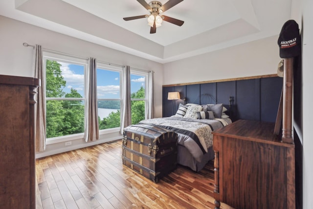 225 Ferguson Creek Rd, Sparta, TN 38583 - bedroom featuring a raised ceiling, wood finished floors, ceiling fan, baseboards, and a water view
