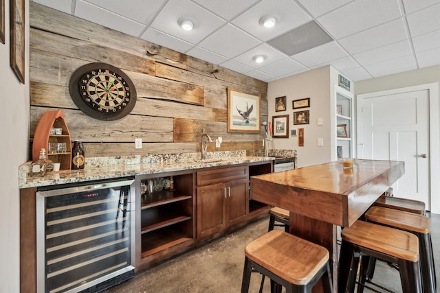 225 Ferguson Creek Rd, Sparta, TN 38583 - indoor wet bar featuring beverage cooler, wooden walls, concrete flooring, and a paneled ceiling