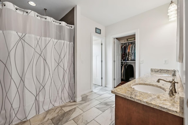 225 Ferguson Creek Rd, Sparta, TN 38583 - bathroom featuring marble finish floors, baseboards, double vanity, a spacious closet, and a shower with shower curtain