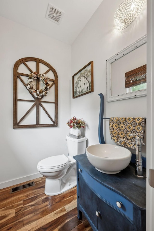 225 Ferguson Creek Rd, Sparta, TN 38583 - half bathroom featuring vanity, wood finished floors, and toilet