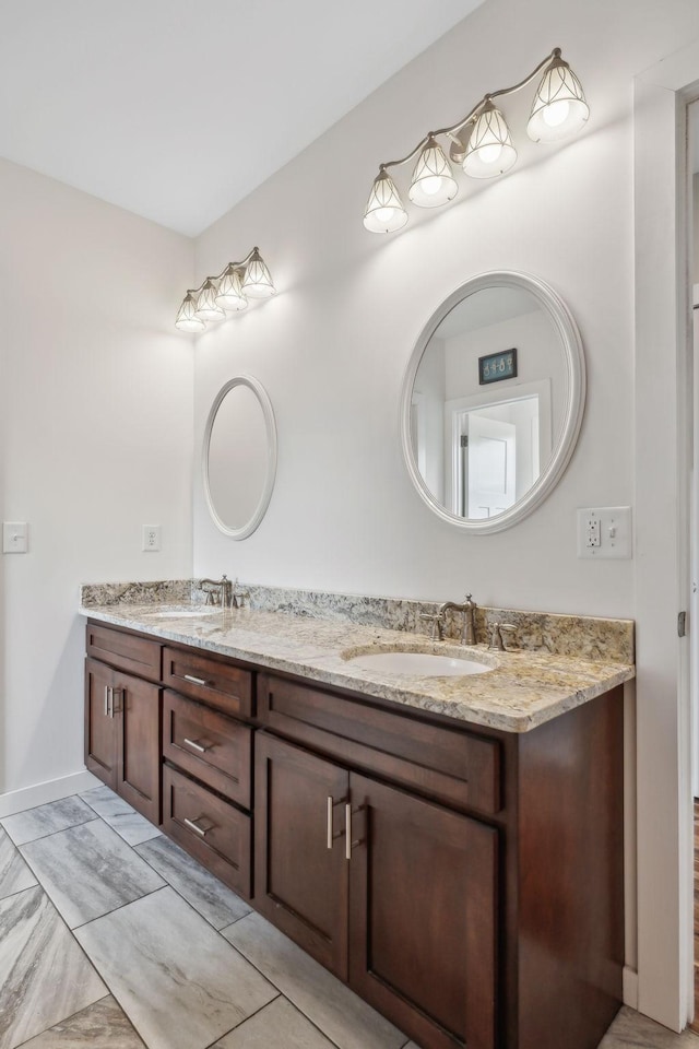 225 Ferguson Creek Rd, Sparta, TN 38583 - bathroom featuring double vanity, baseboards, and marble look tile flooring