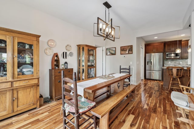 225 Ferguson Creek Rd, Sparta, TN 38583 - dining space featuring wood finished floors, a chandelier, vaulted ceiling, and recessed lighting