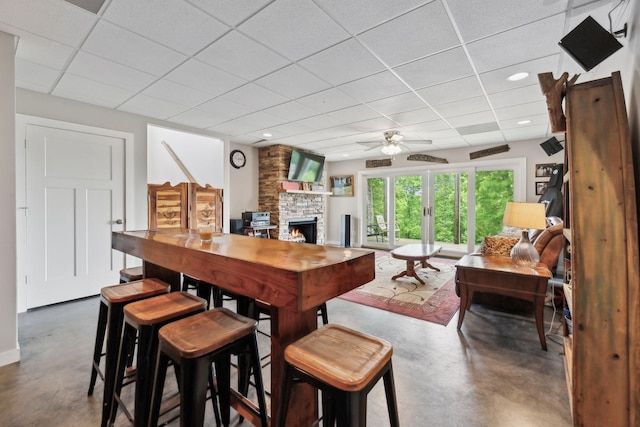 225 Ferguson Creek Rd, Sparta, TN 38583 - dining space with finished concrete flooring, a paneled ceiling, a fireplace, a ceiling fan, and recessed lighting