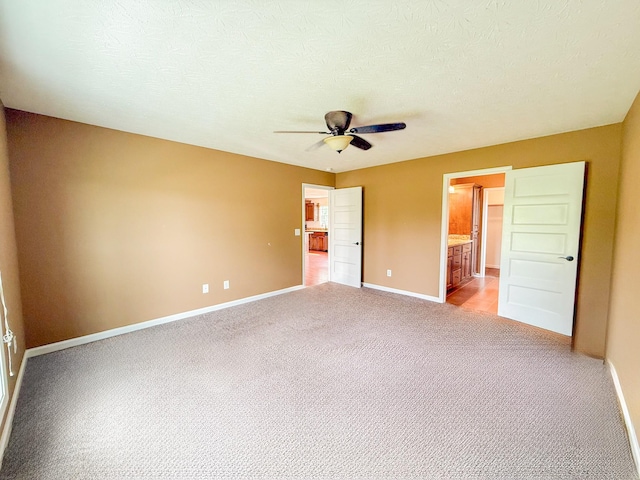 41 Haven Way, Westmoreland, TN 37186 - unfurnished bedroom with light carpet, baseboards, ensuite bathroom, and a ceiling fan