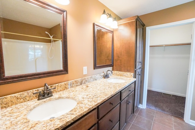 41 Haven Way, Westmoreland, TN 37186 - bathroom with tile patterned floors, double vanity, a walk in closet, and baseboards