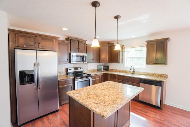 41 Haven Way, Westmoreland, TN 37186 - kitchen with stainless steel appliances, a sink, dark wood finished floors, light stone countertops, and recessed lighting