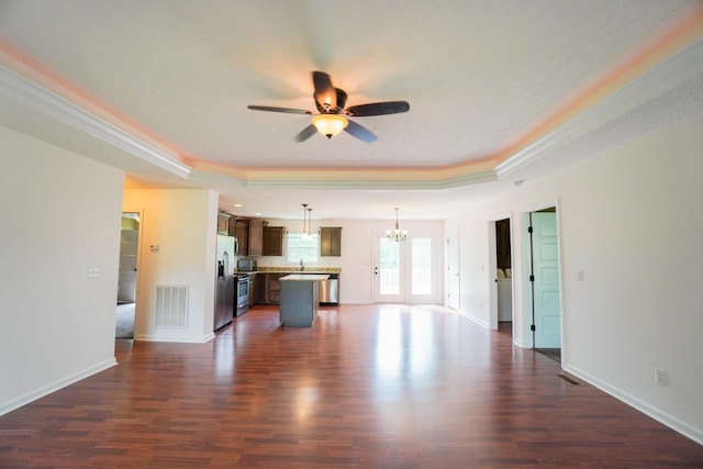 41 Haven Way, Westmoreland, TN 37186 - unfurnished living room featuring a raised ceiling, dark wood-style floors, a ceiling fan, a chandelier, and ornamental molding