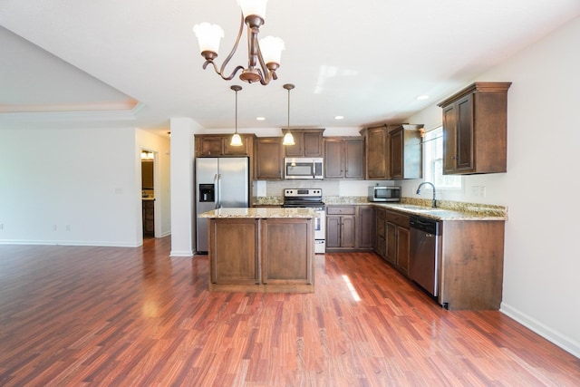 41 Haven Way, Westmoreland, TN 37186 - kitchen with stainless steel appliances, baseboards, dark wood-style flooring, a sink, and a chandelier