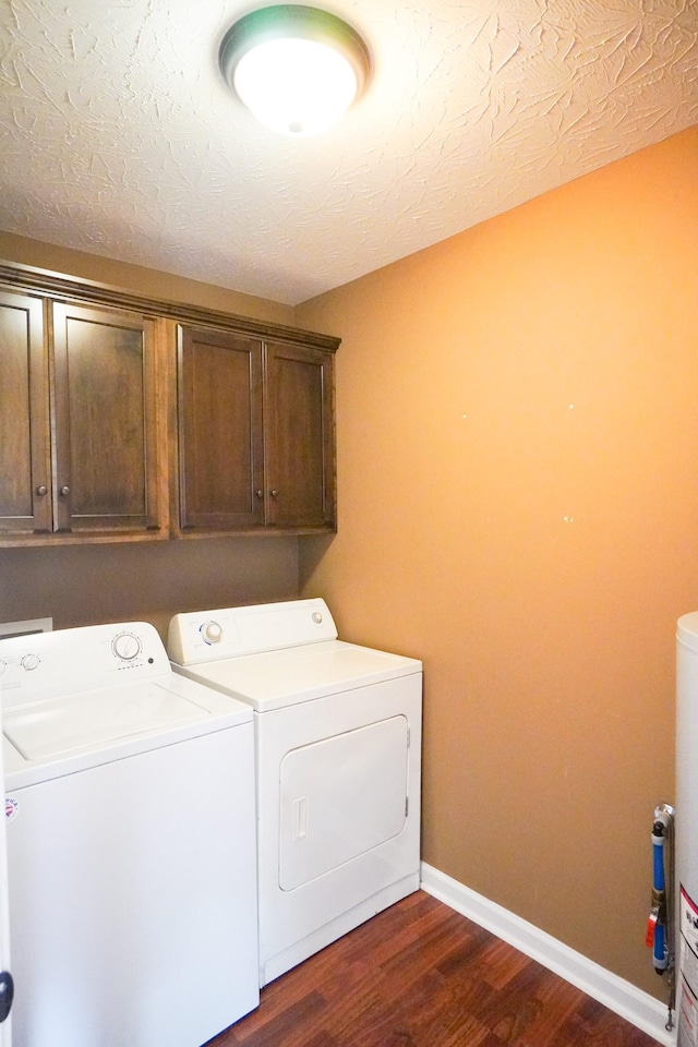 41 Haven Way, Westmoreland, TN 37186 - laundry area with cabinet space, washing machine and dryer, dark wood finished floors, and baseboards