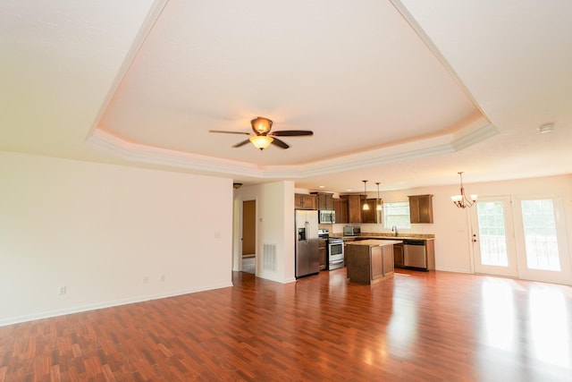 41 Haven Way, Westmoreland, TN 37186 - unfurnished living room featuring a raised ceiling, a chandelier, dark wood finished floors, ceiling fan, and baseboards