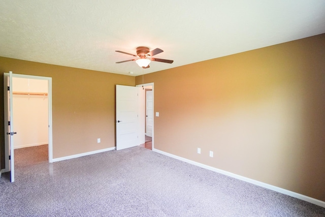 41 Haven Way, Westmoreland, TN 37186 - unfurnished bedroom with baseboards, a walk in closet, carpet floors, a closet, and ceiling fan