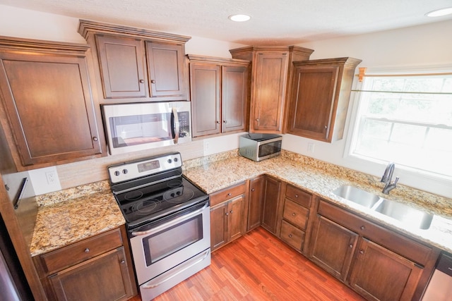 41 Haven Way, Westmoreland, TN 37186 - kitchen with stainless steel appliances, a sink, light wood-style flooring, light stone countertops, and recessed lighting