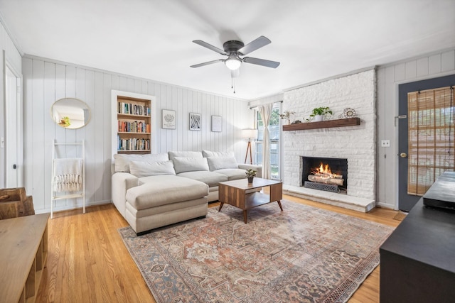 808 Winthorne Ct, Nashville, TN 37217 - living room with light wood-style floors, ceiling fan, a fireplace, and wooden walls